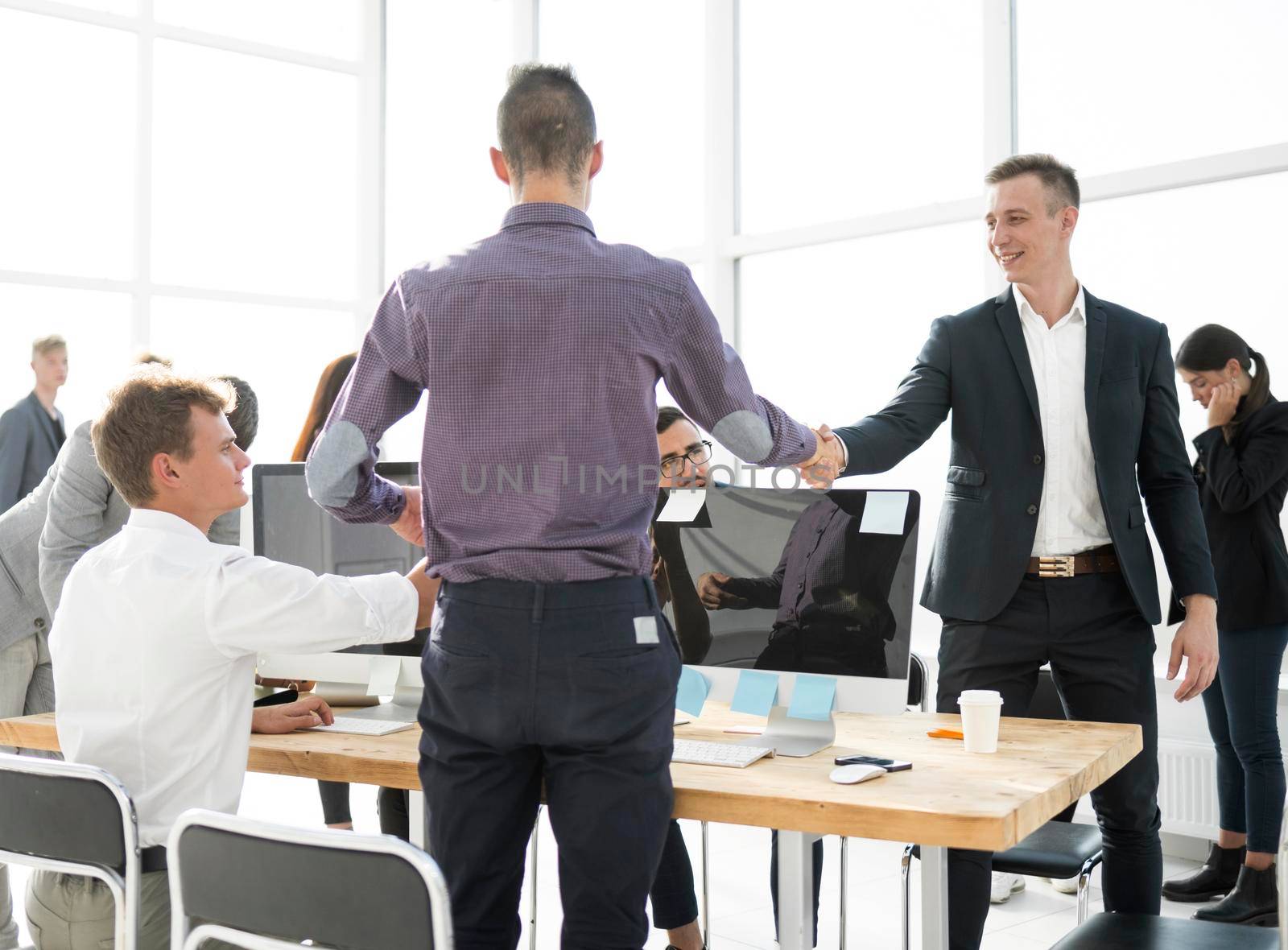 business colleagues greeting each other at the workplace. business concept
