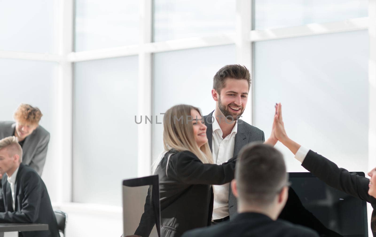 happy employees giving each other a high five. the concept of success.