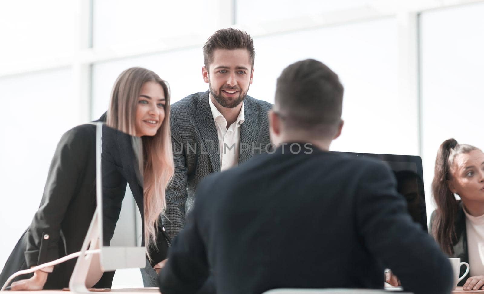 group of employees discussing something standing in the office. office workdays