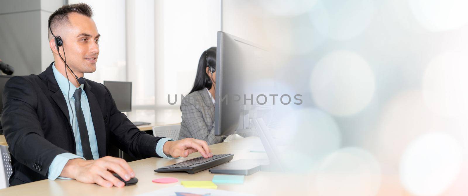 Business people wearing headset working in office broaden view by biancoblue