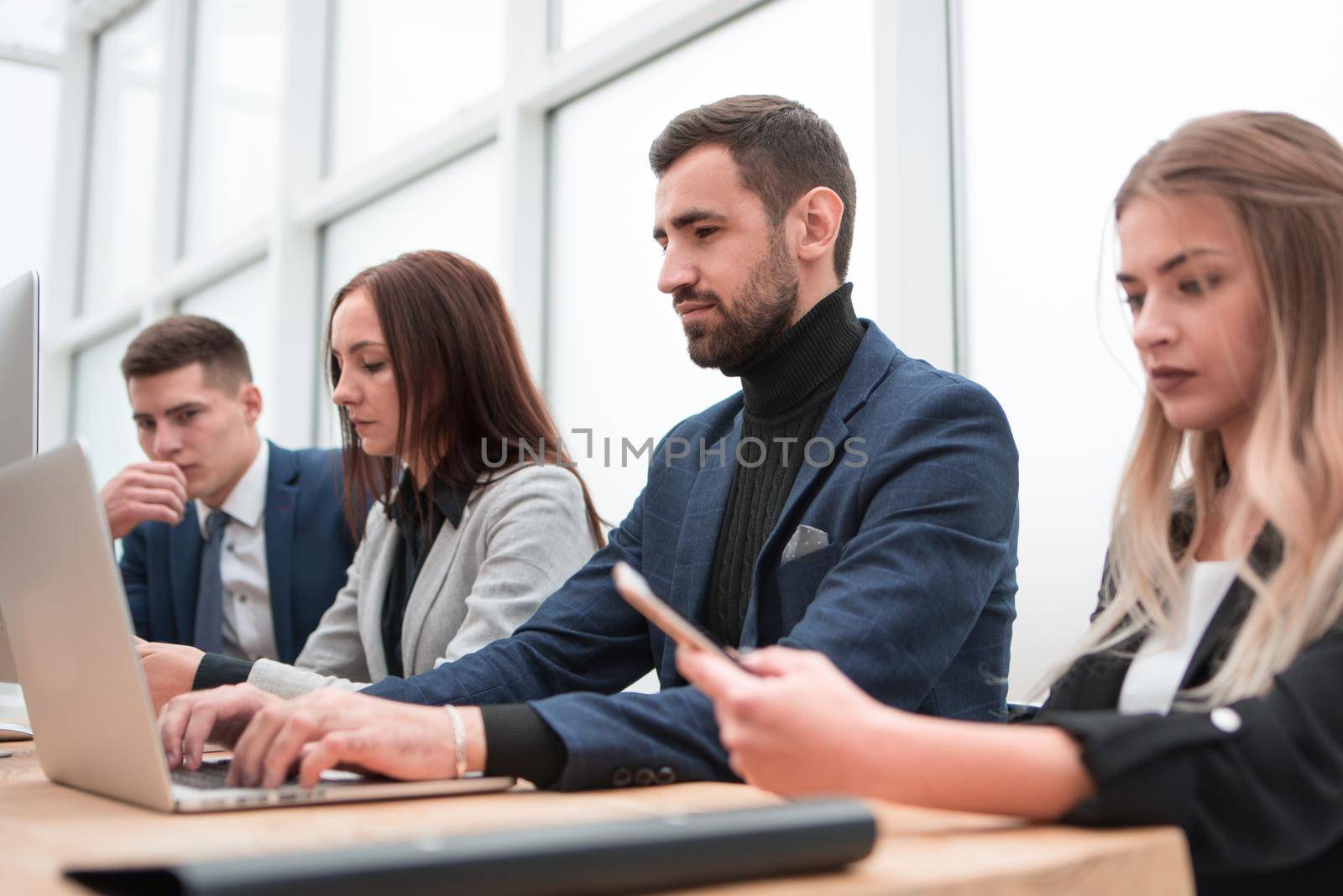 business team works on computers in a modern office. office workdays