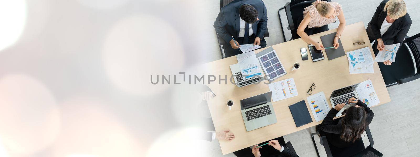 Business people group meeting shot from top widen view in office . Profession businesswomen, businessmen and office workers working in team conference with project planning document on meeting table .