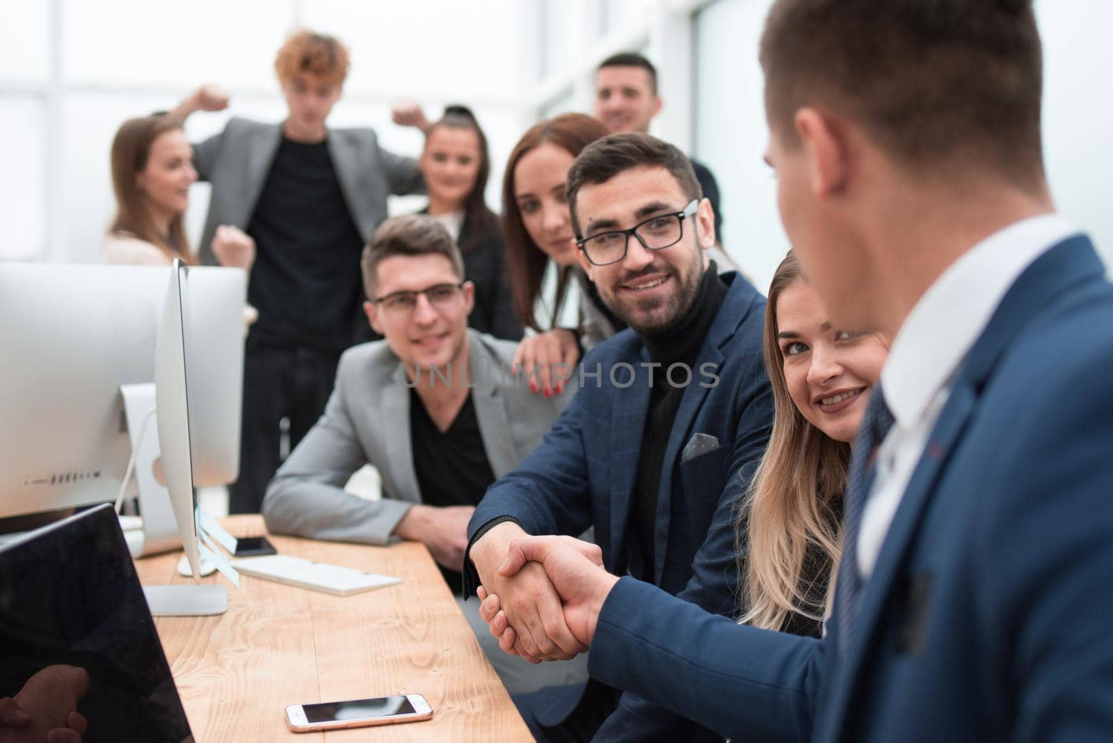 close up. business colleagues shaking hands at the workplace