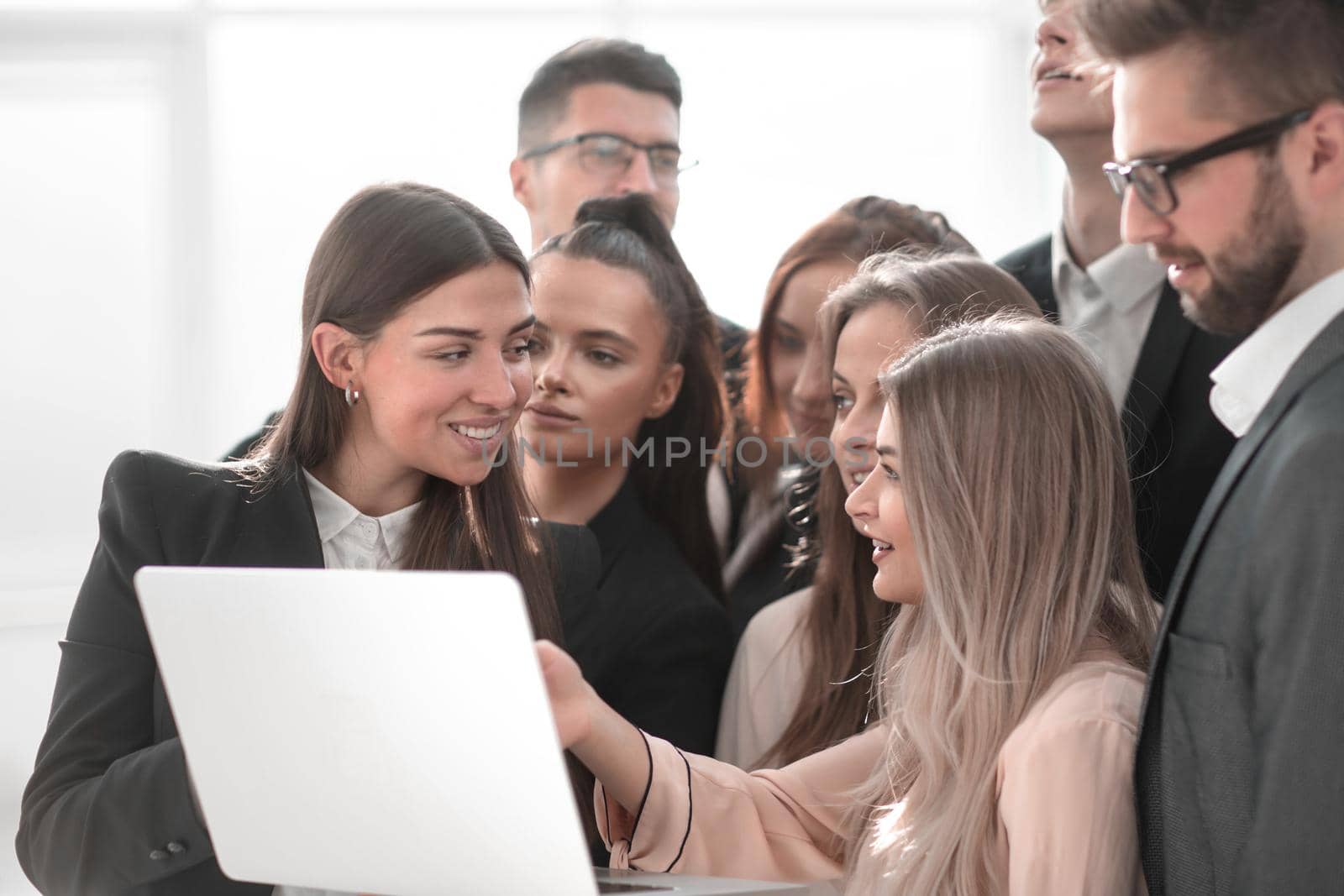 close up. business team looks at the laptop screen together.