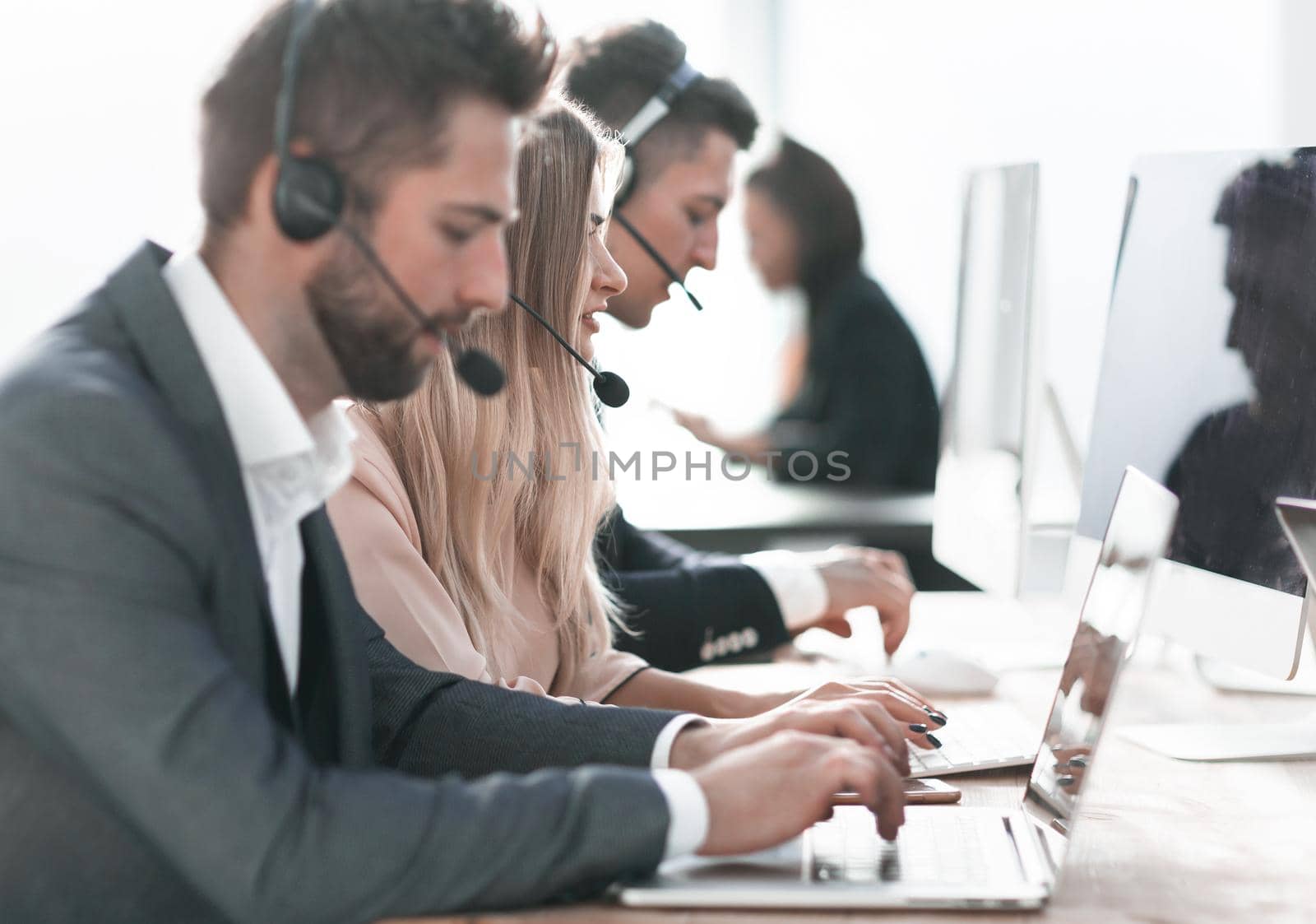 close up. call center operators using laptops to work with clients.