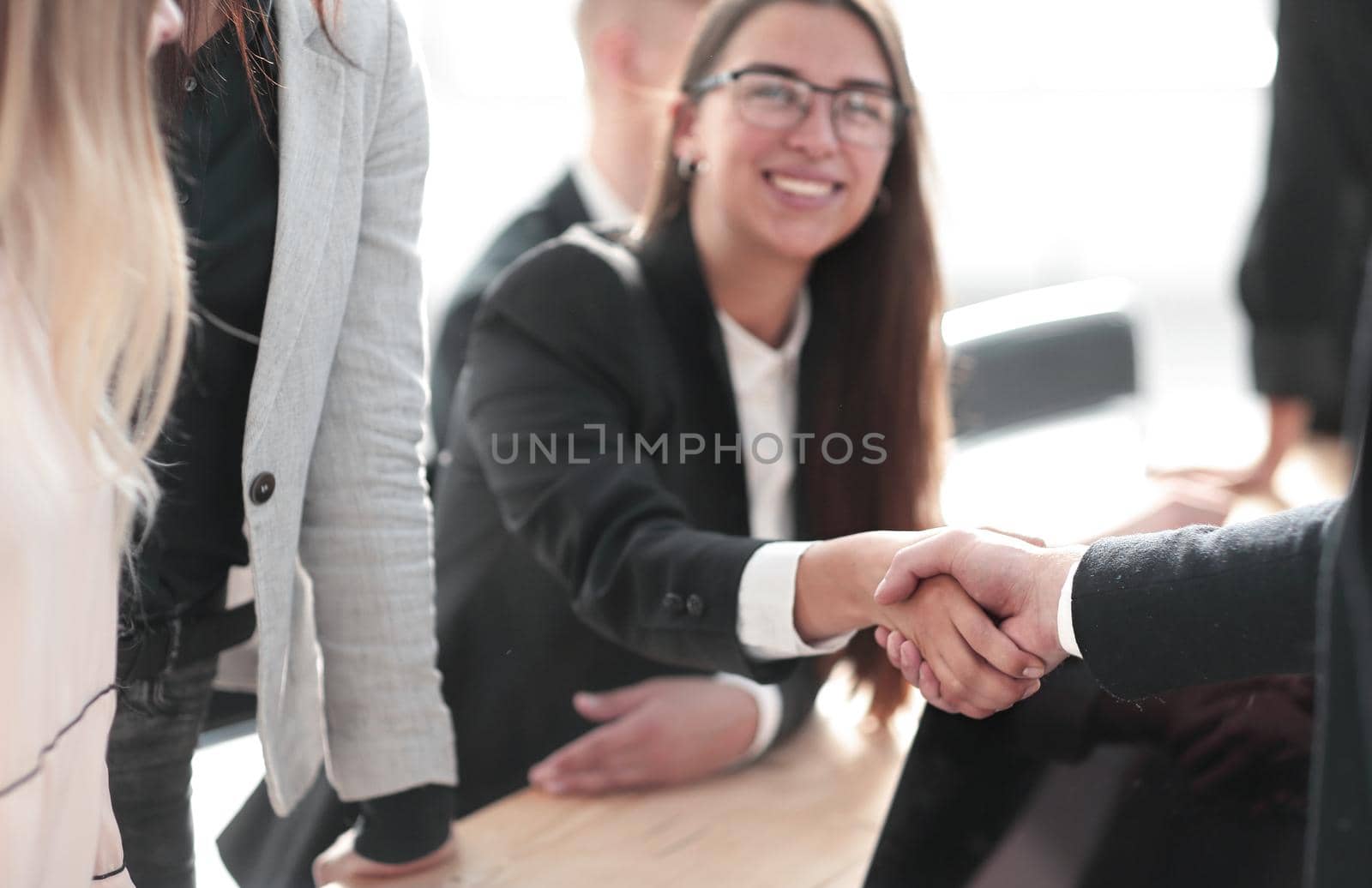 close up. smiling businesswoman shaking hands with her business partner. the concept of cooperation