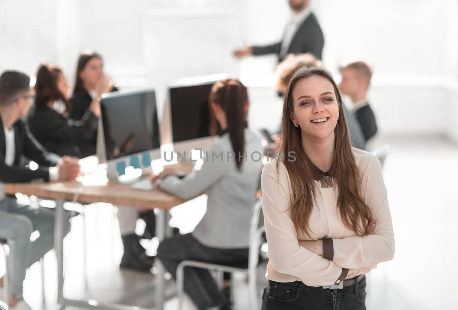 portrait of a young woman standing in a modern office by asdf