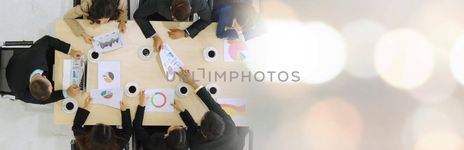 Business people group meeting shot from top view in office . Profession businesswomen, businessmen and office workers working in team conference with project planning document broaden view .