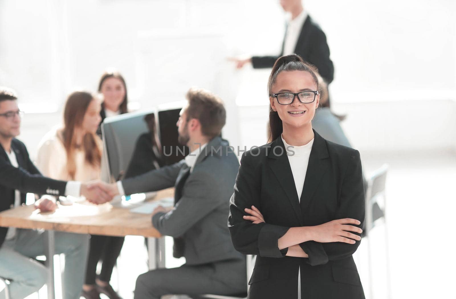 young corporate employee standing in a modern office by asdf