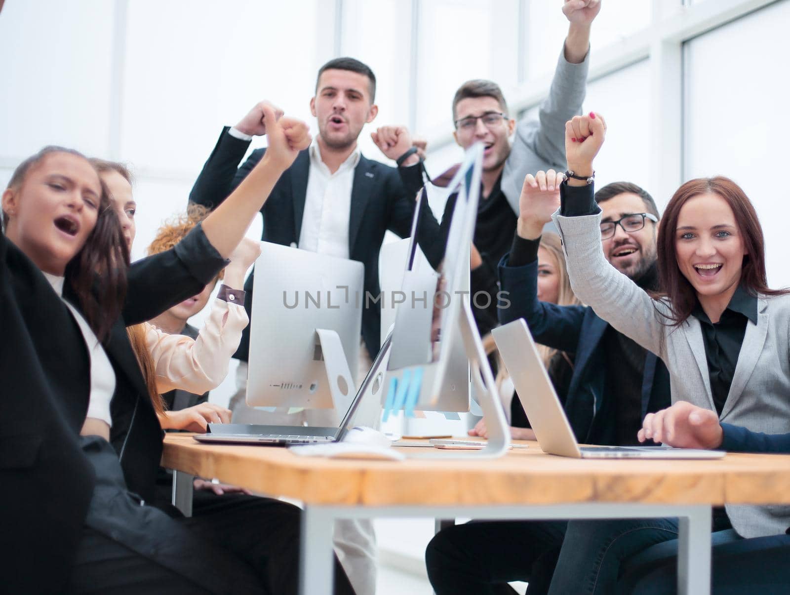 group of happy office employees sitting at a table. success concept