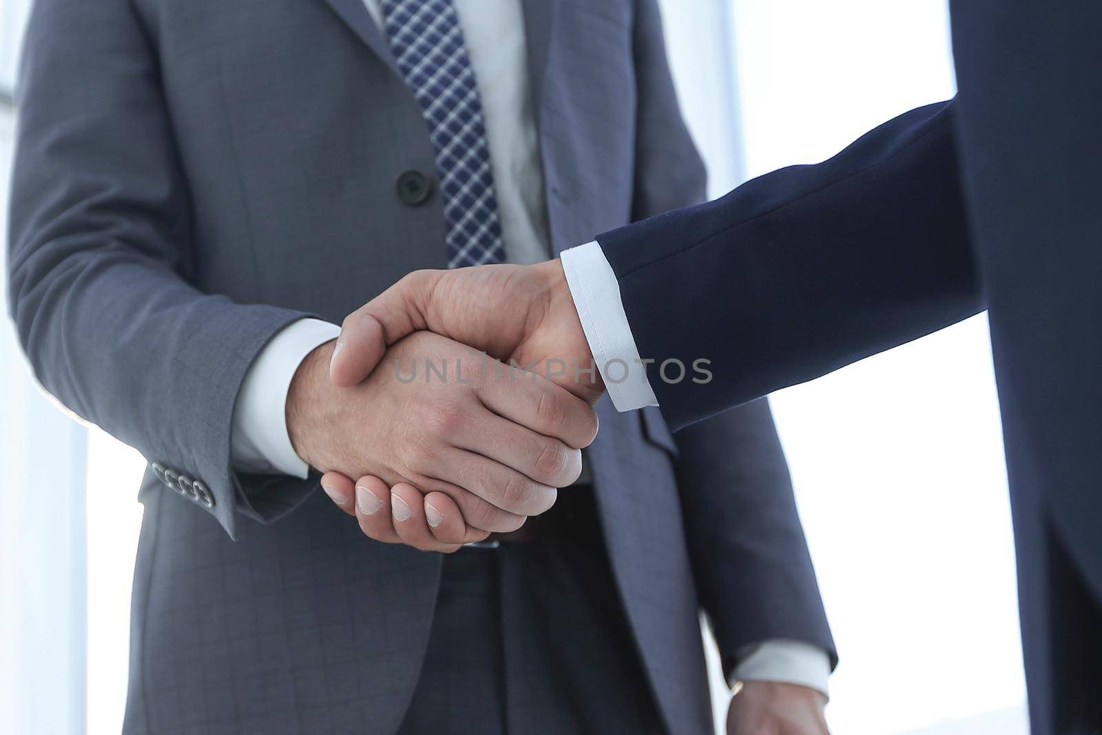 Friendly businessmen handshaking. Business concept photo