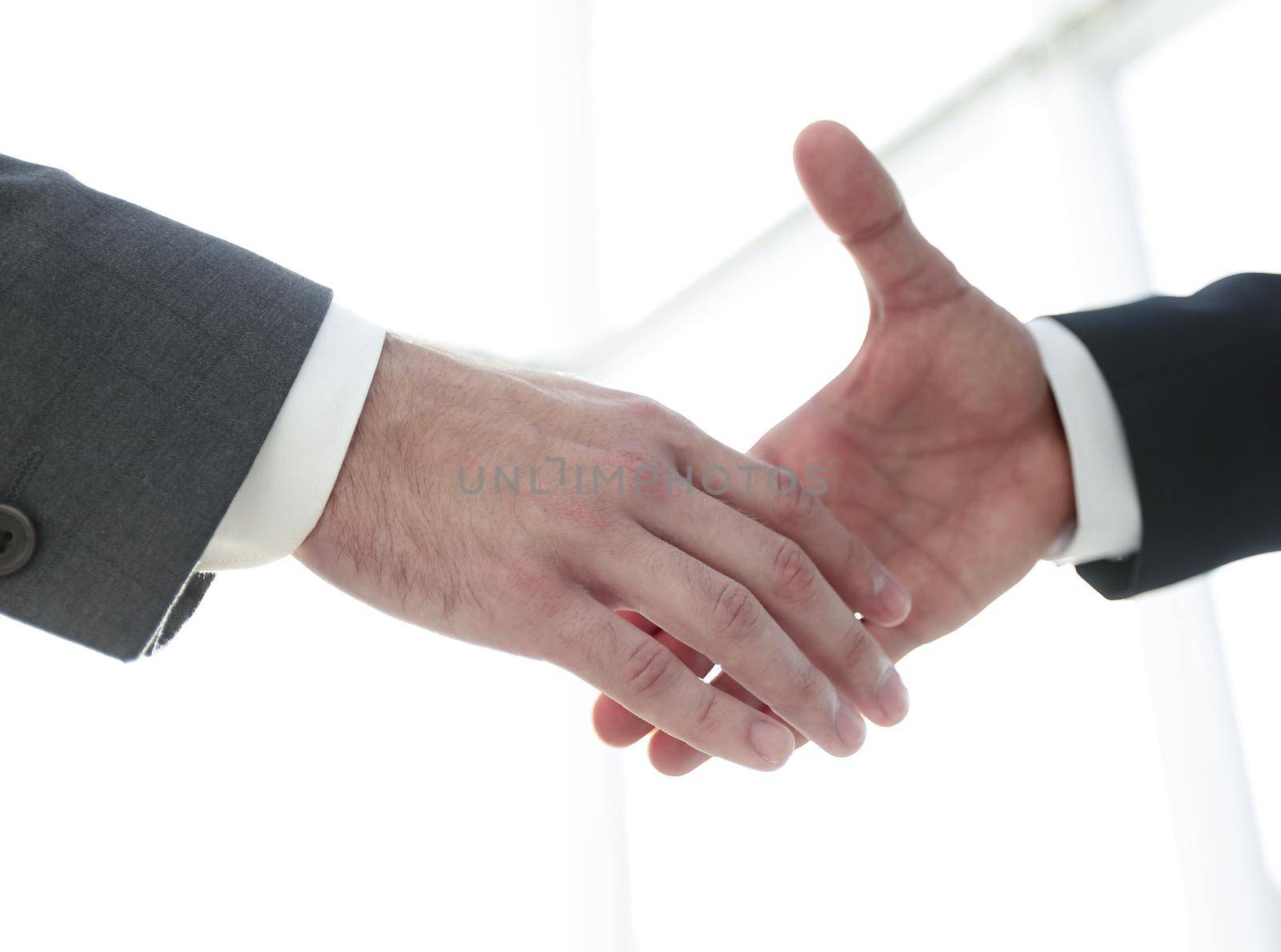 Two business men going to make handshake by asdf