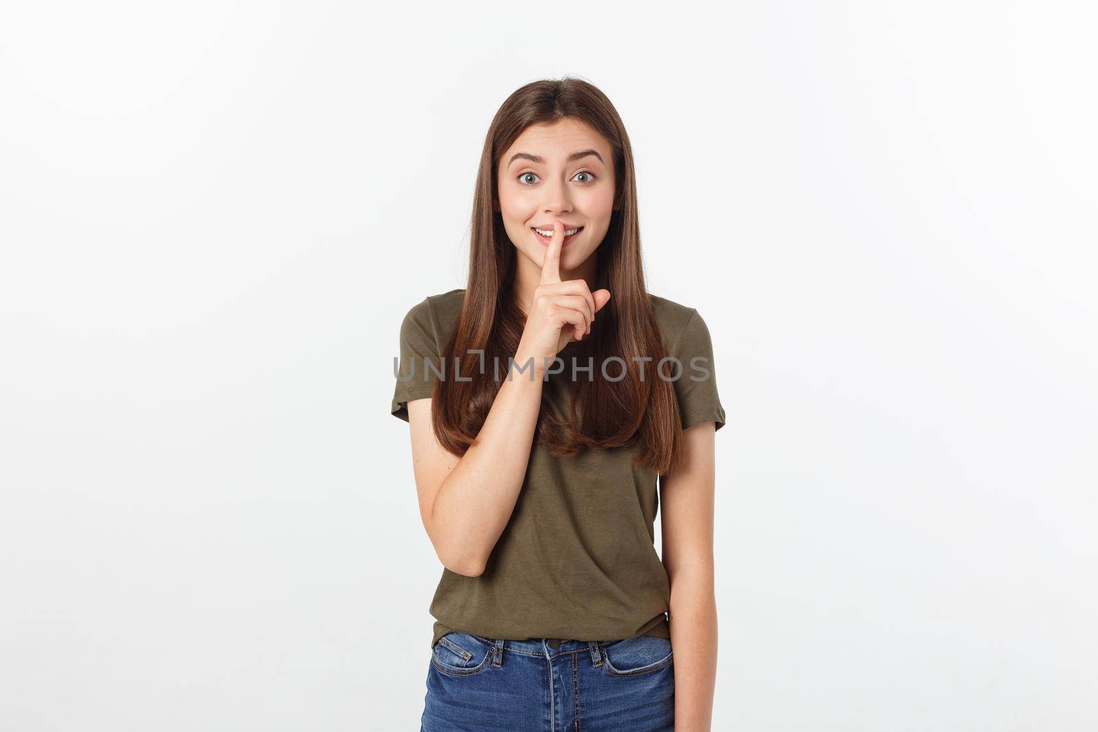 Beautiful woman showing finger over lips isolated on a white background