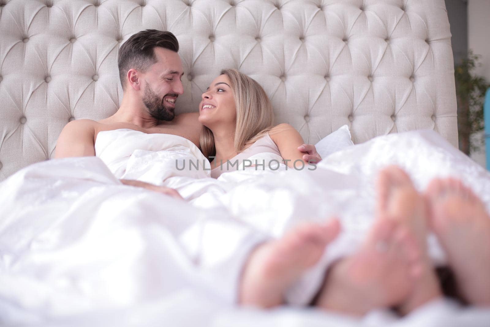 close up. loving couple talking while lying on the bed