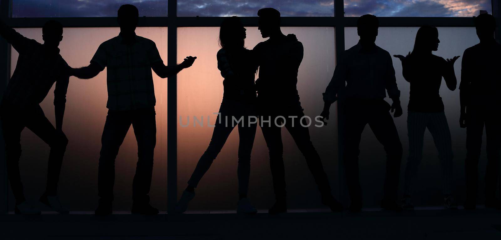 group of creative young people on the background of a large window.photo with text space