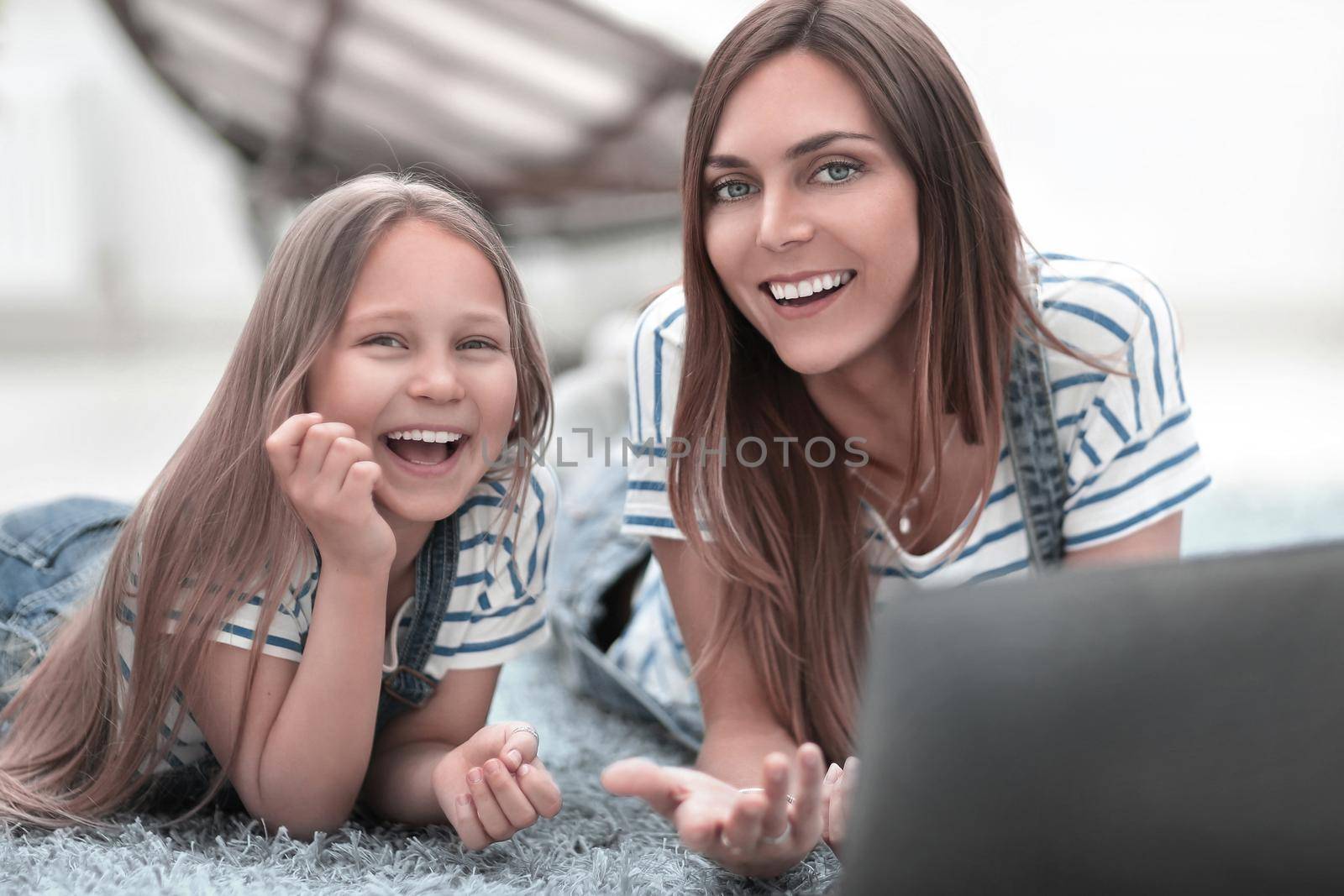 smiling mother and daughter spend their free time together by asdf