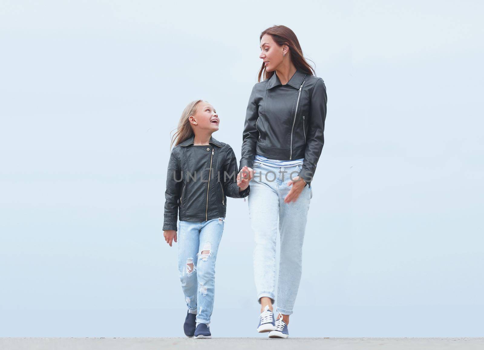 mother holds her daughter's hand tightly. photo with copy space