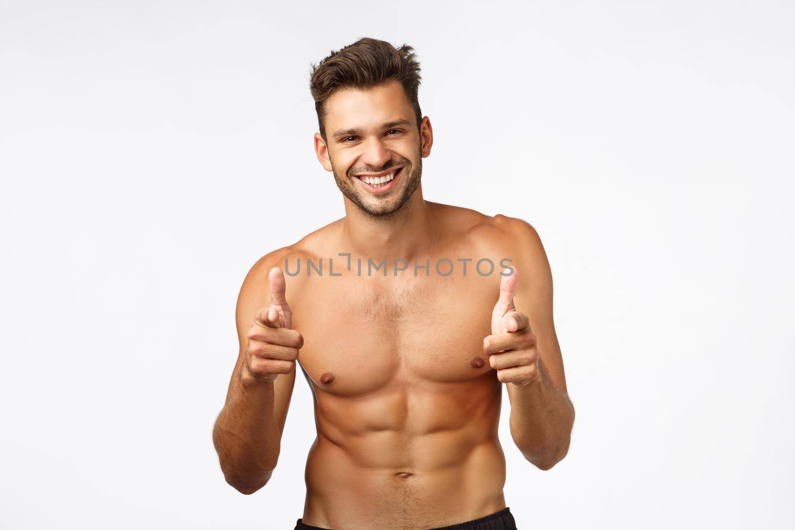 Handsome charming bearded young guy with naked torso, perfect body six-pack, finish workout, thanking instructor, show thumbs-up and smiling in approval, give positive feedback about gym, exercises.