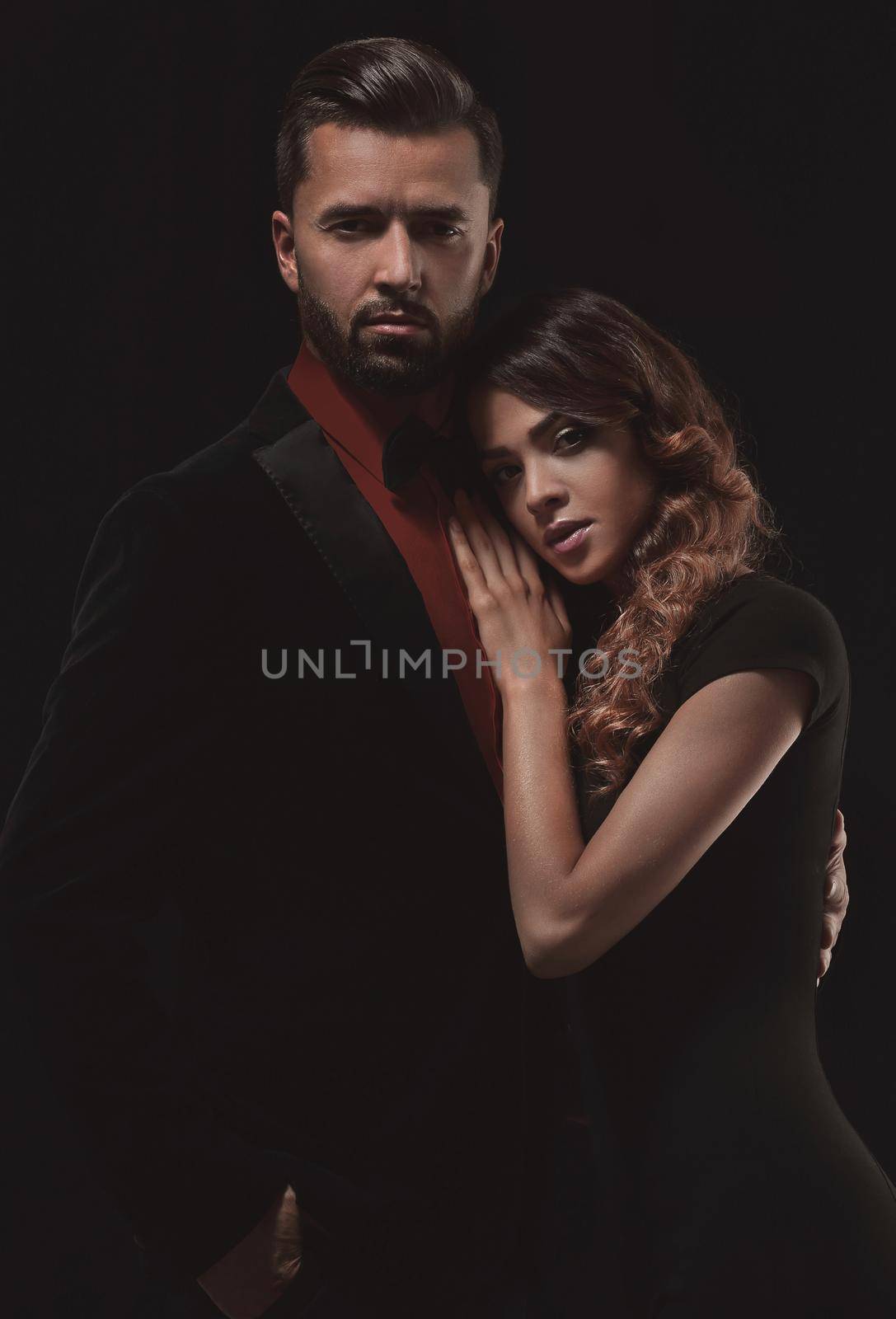 portrait of fashion couple on black background by asdf