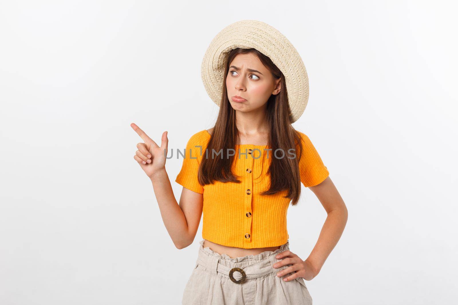 young pretty woman looking unhappy and stressed, suicide gesture making gun sign with hand, pointing to copy space