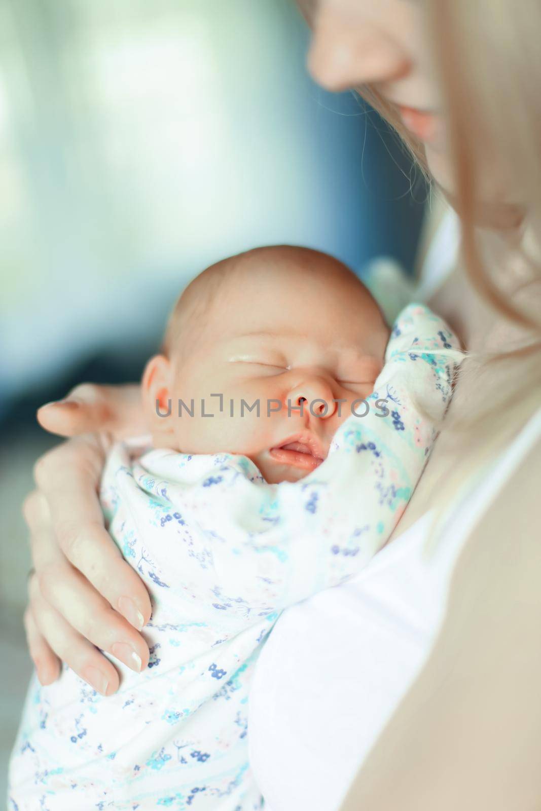 close up. happy mom with a newborn baby in her arms.