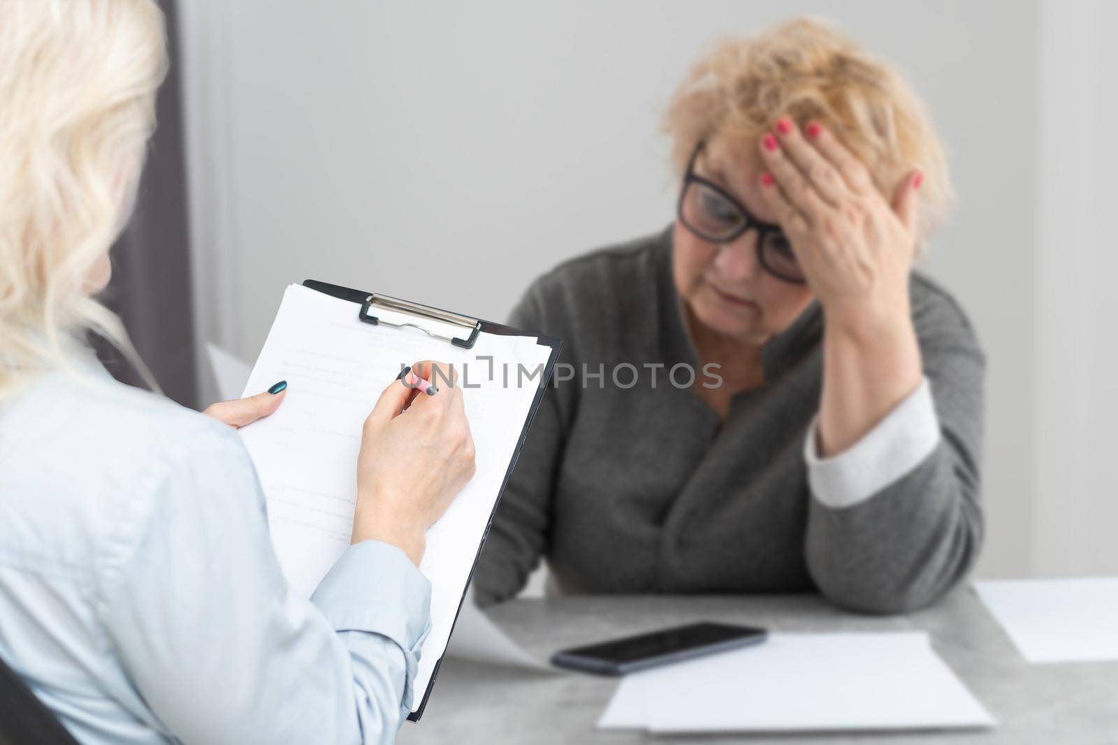 female doctor consulting mature patient about treatment at meeting in hospital office, therapist and senior woman discussing checkup results, healthcare by Andelov13