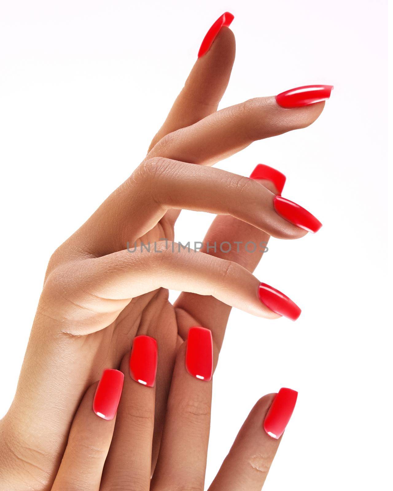 Beautiful woman's hands on light background. Care about hand. Redl manicure, clean skin. Bright nails with polish on white background