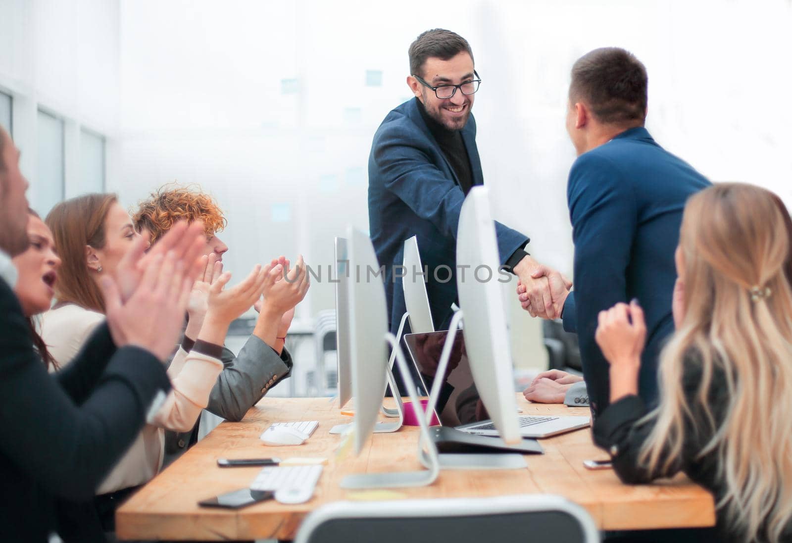 business people shaking hands at a work meeting by asdf