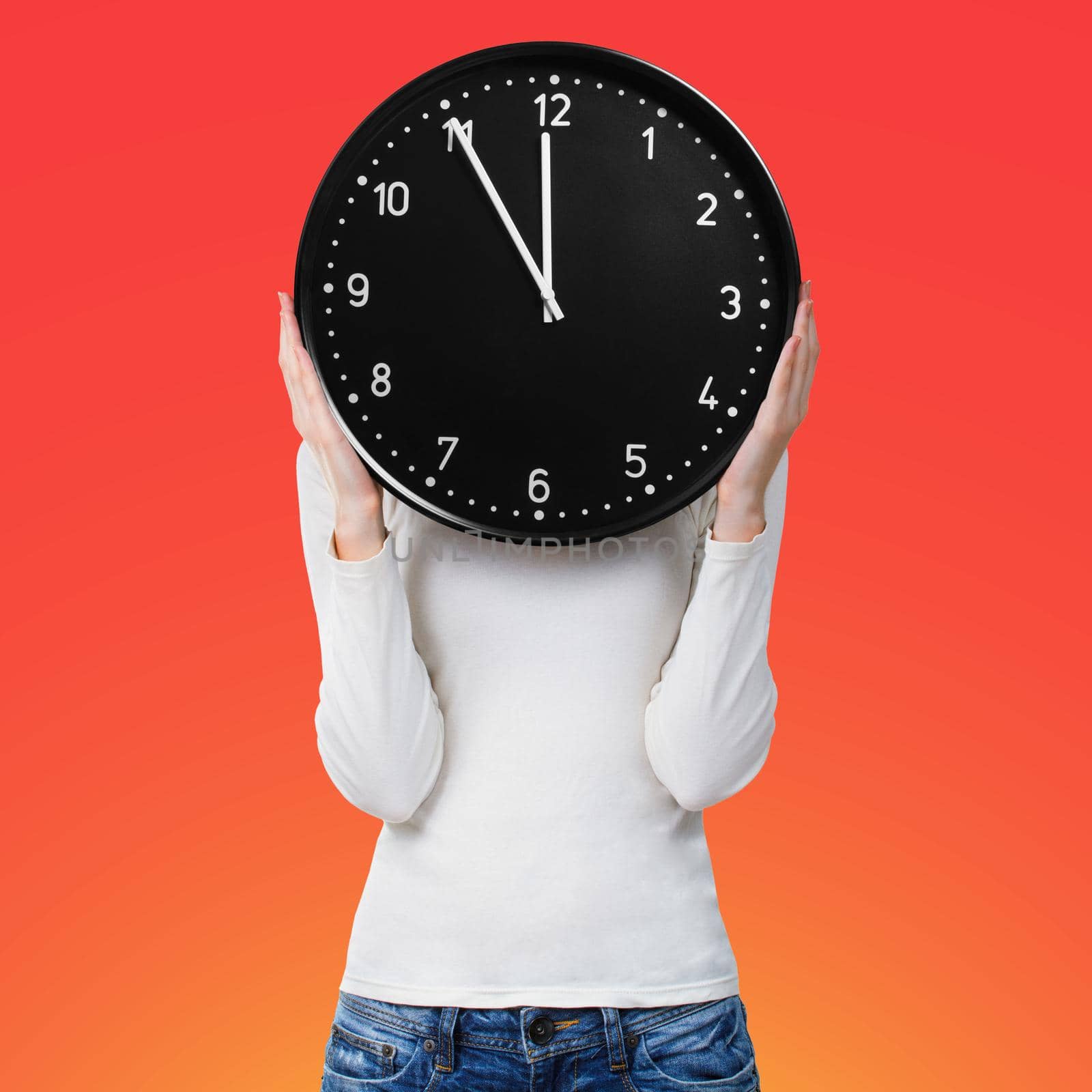 Woman with clock over face on bright red background. Time concept