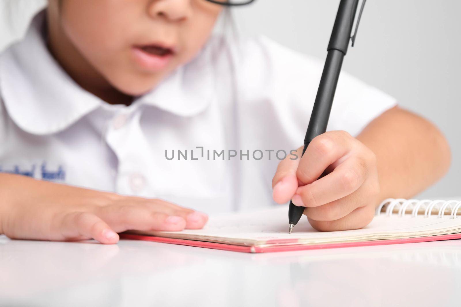 Small businesswoman taking notes while working in the office. Children and business concepts