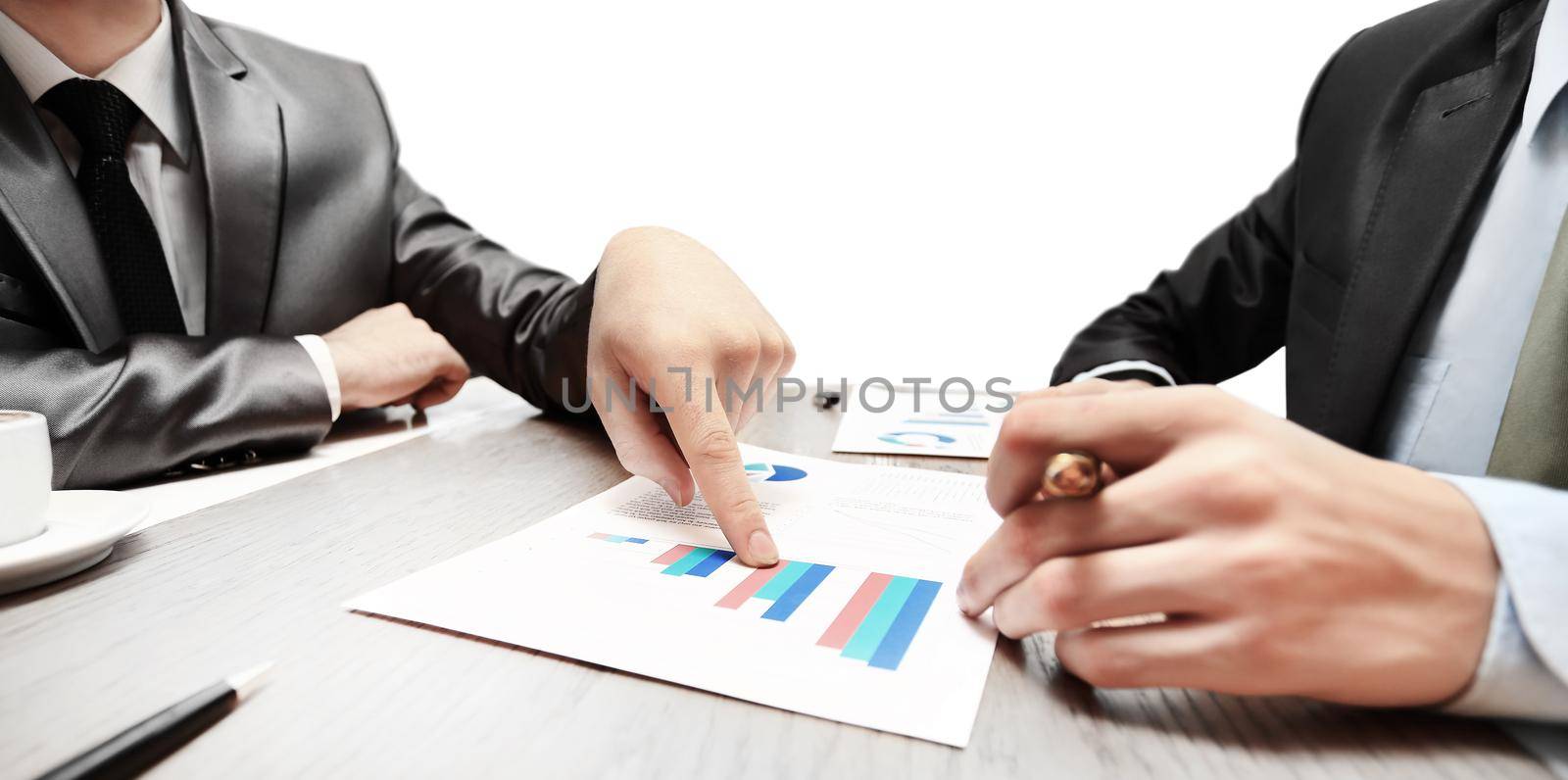 work of two young businessmen using touchpad at meeting by SmartPhotoLab