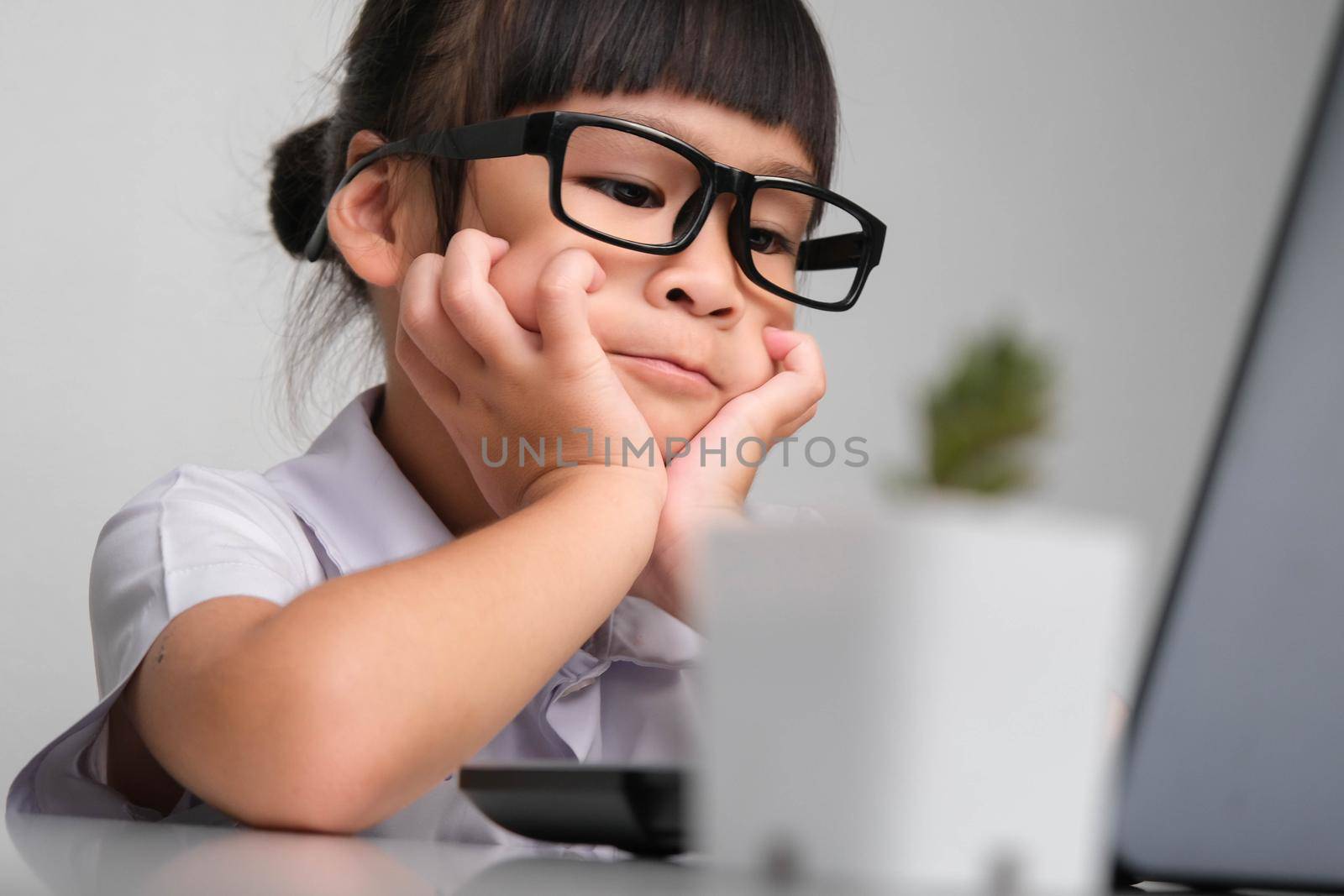 Boring job. Little businesswoman with laptop working in office. Children and business concepts