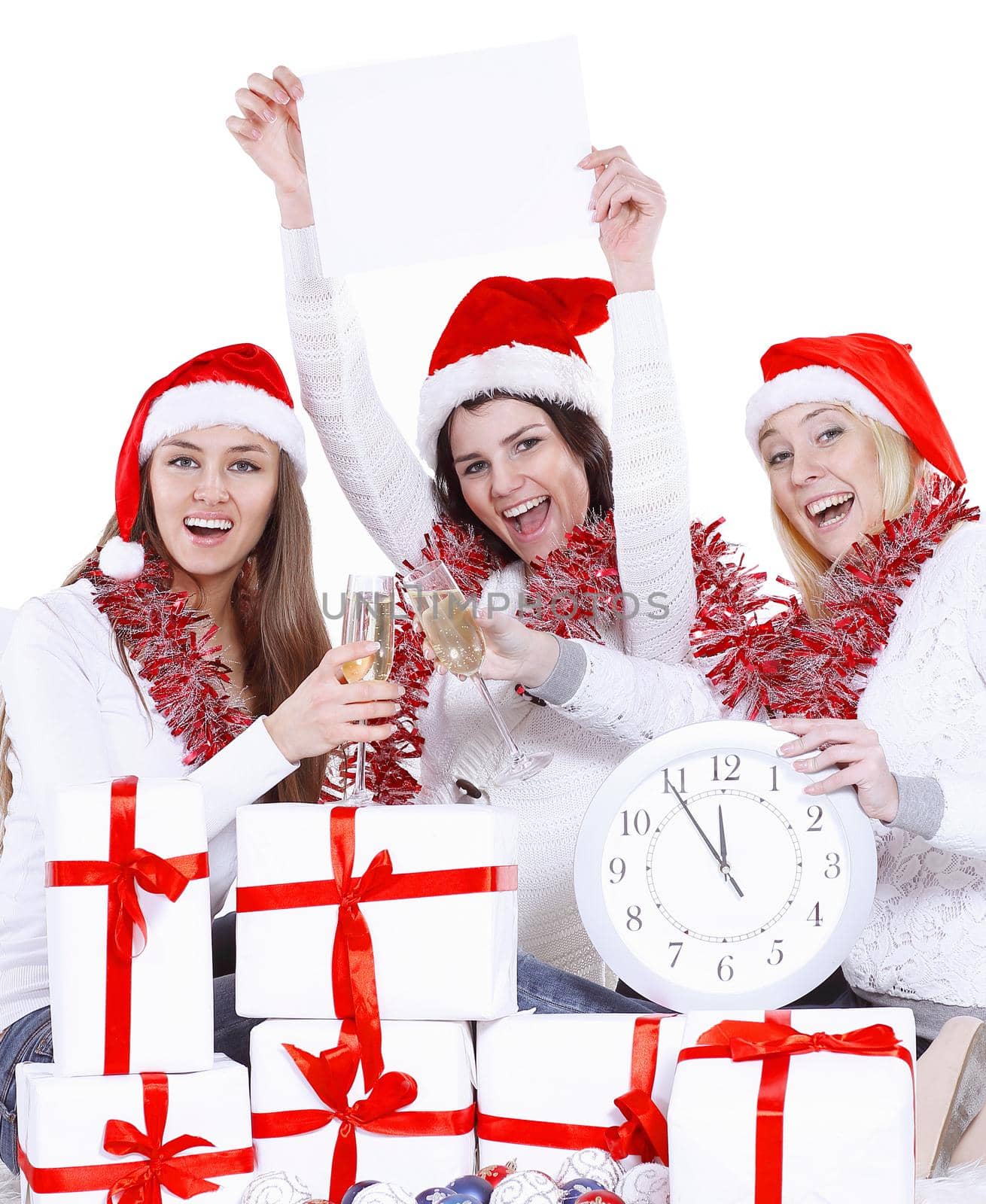 three happy young women in hats of Santa Claus with clock and blank poster congratulating on Christmas . by SmartPhotoLab