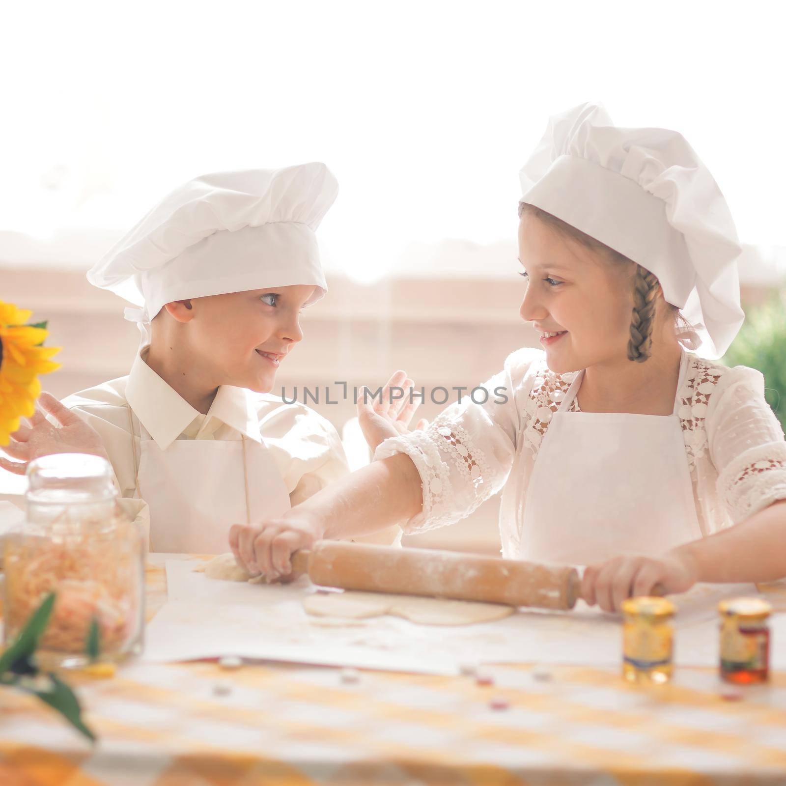 happy little children in the form of a chef to prepare delicious by SmartPhotoLab