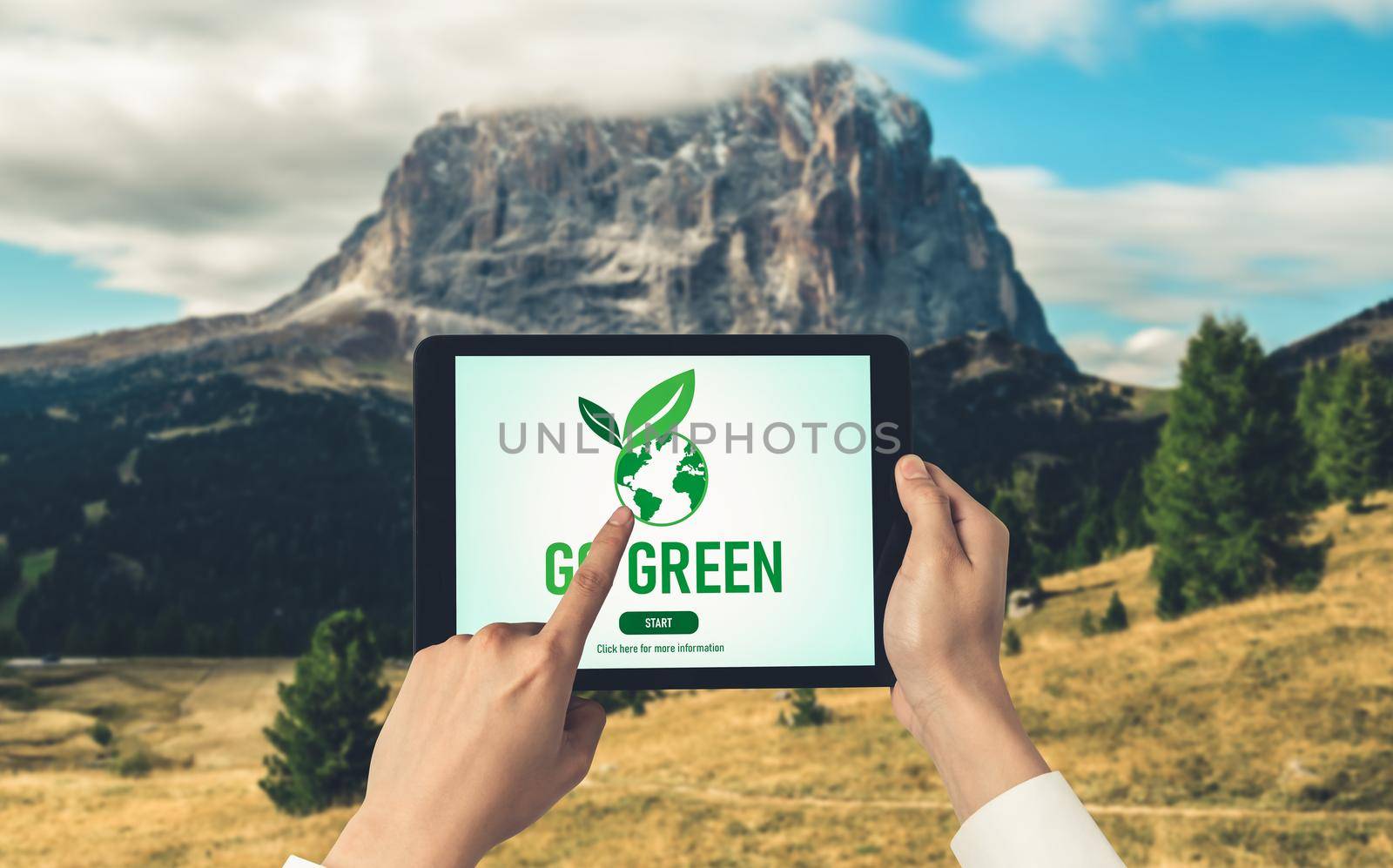 Green business transformation for environment saving and ESG business concept. Businessman using tablet to set corporate goal toward environmental friendly management and alternative clean energy use.