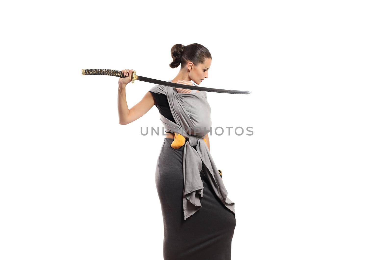 Beautiful young babywearing mother with katana sword protects her baby. Mother protection concept.