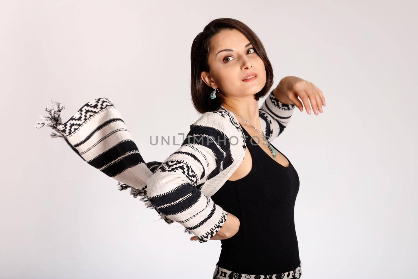 Ethno print clothes on beautiful young woman on white background by Rom4ek