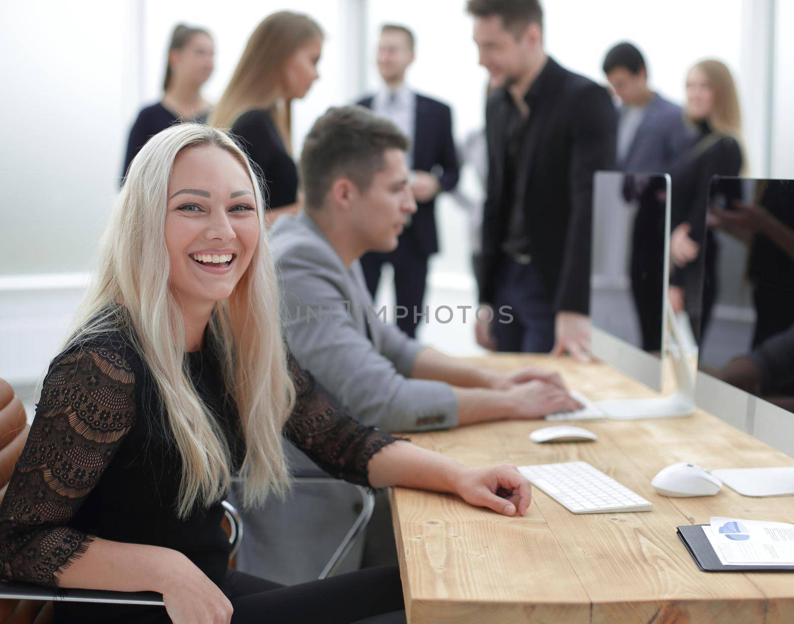 smiling young woman at the workplace, in the office by asdf