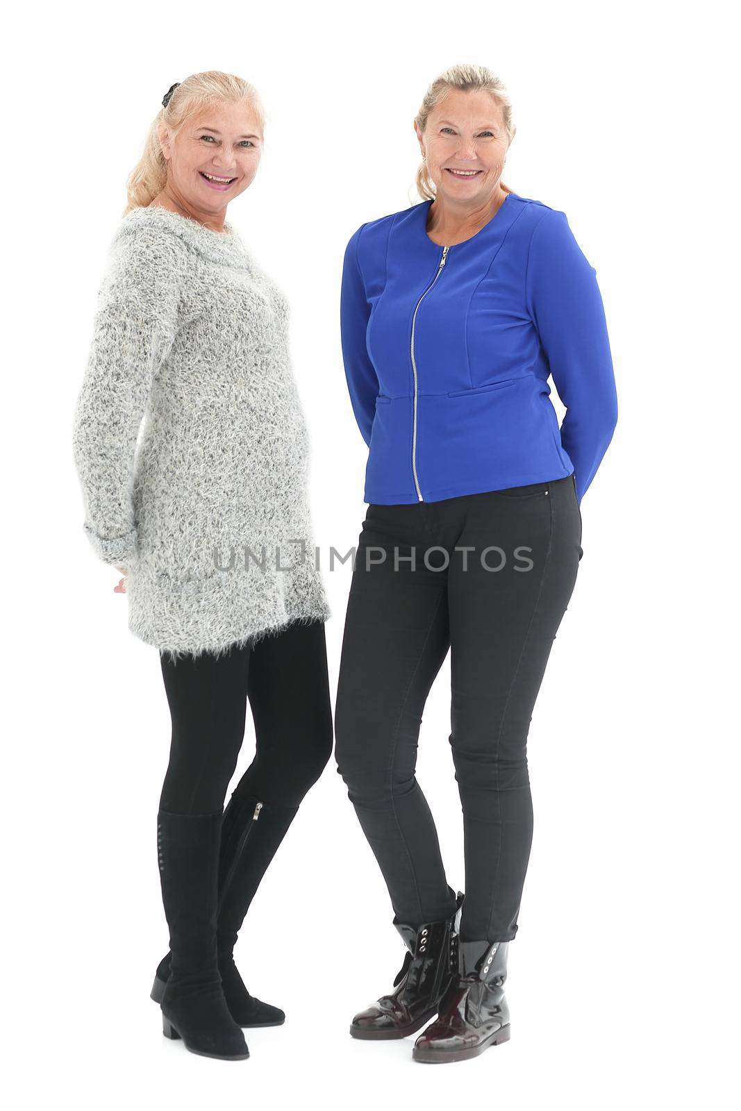 Two happy casual women smiling isolated over a white background