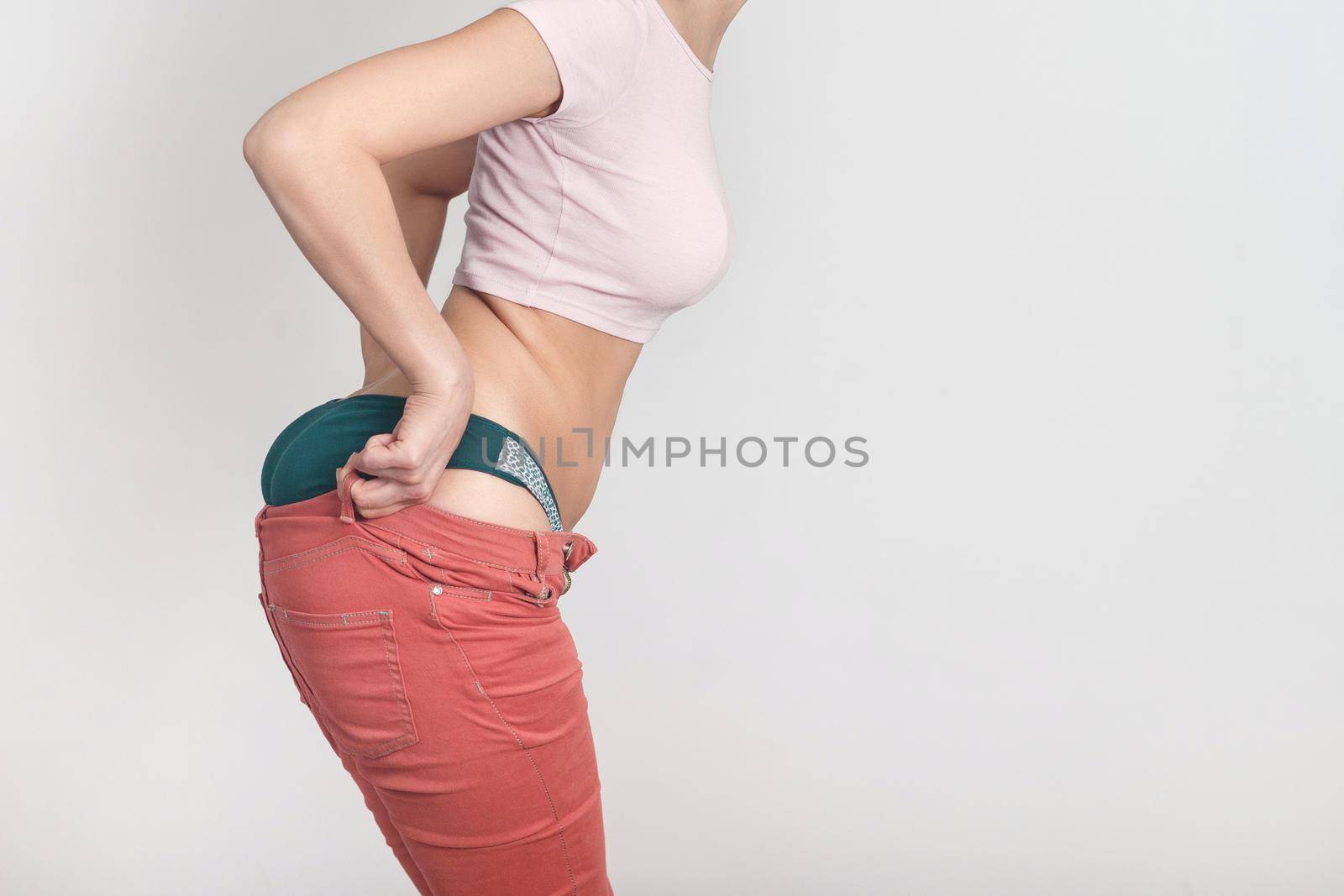 Side view of a young woman who should go in for sports. Diet, overweight, obesity concept.