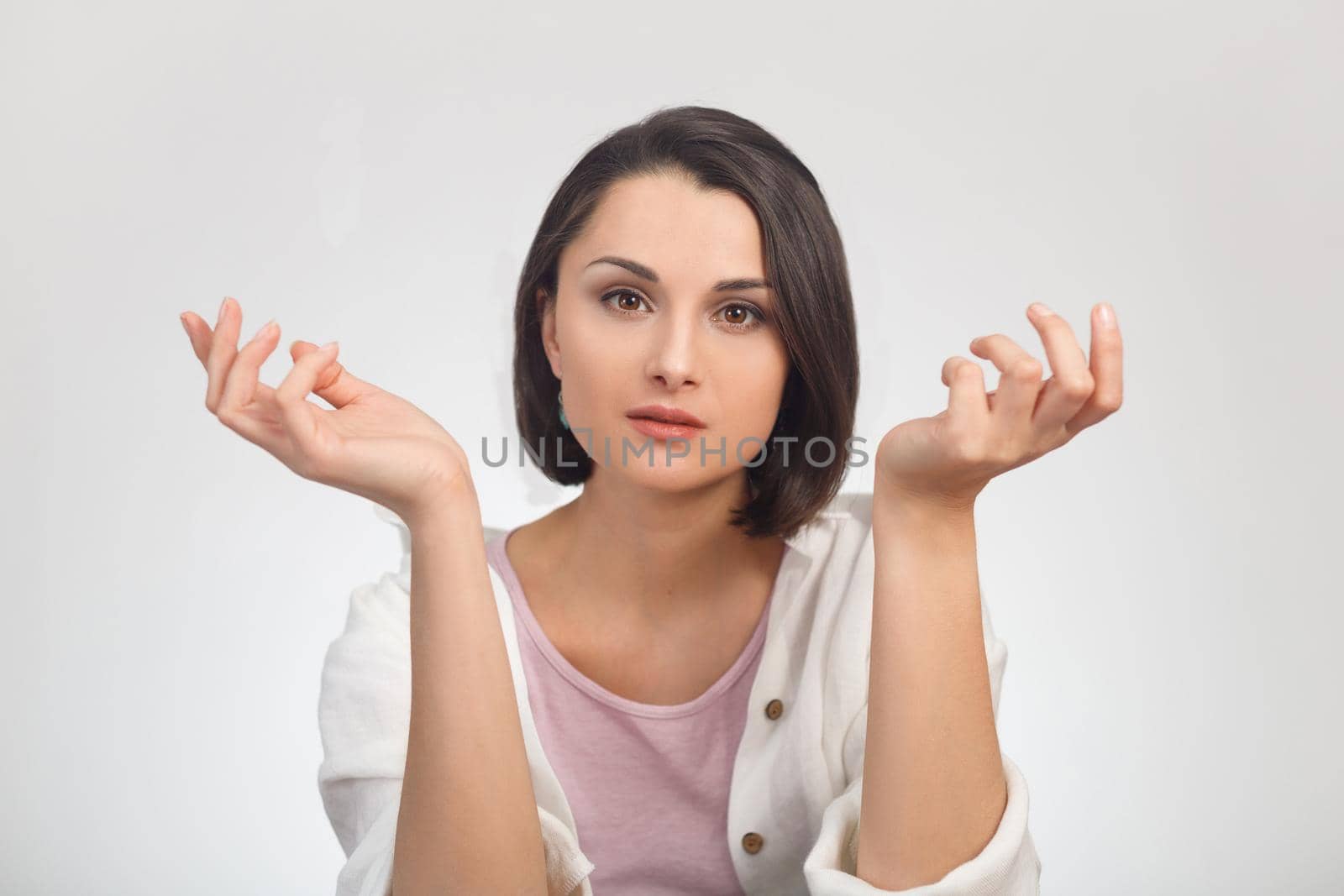 High key portrait of a young woman looking at the camera and spreading her arms in different directions by Rom4ek