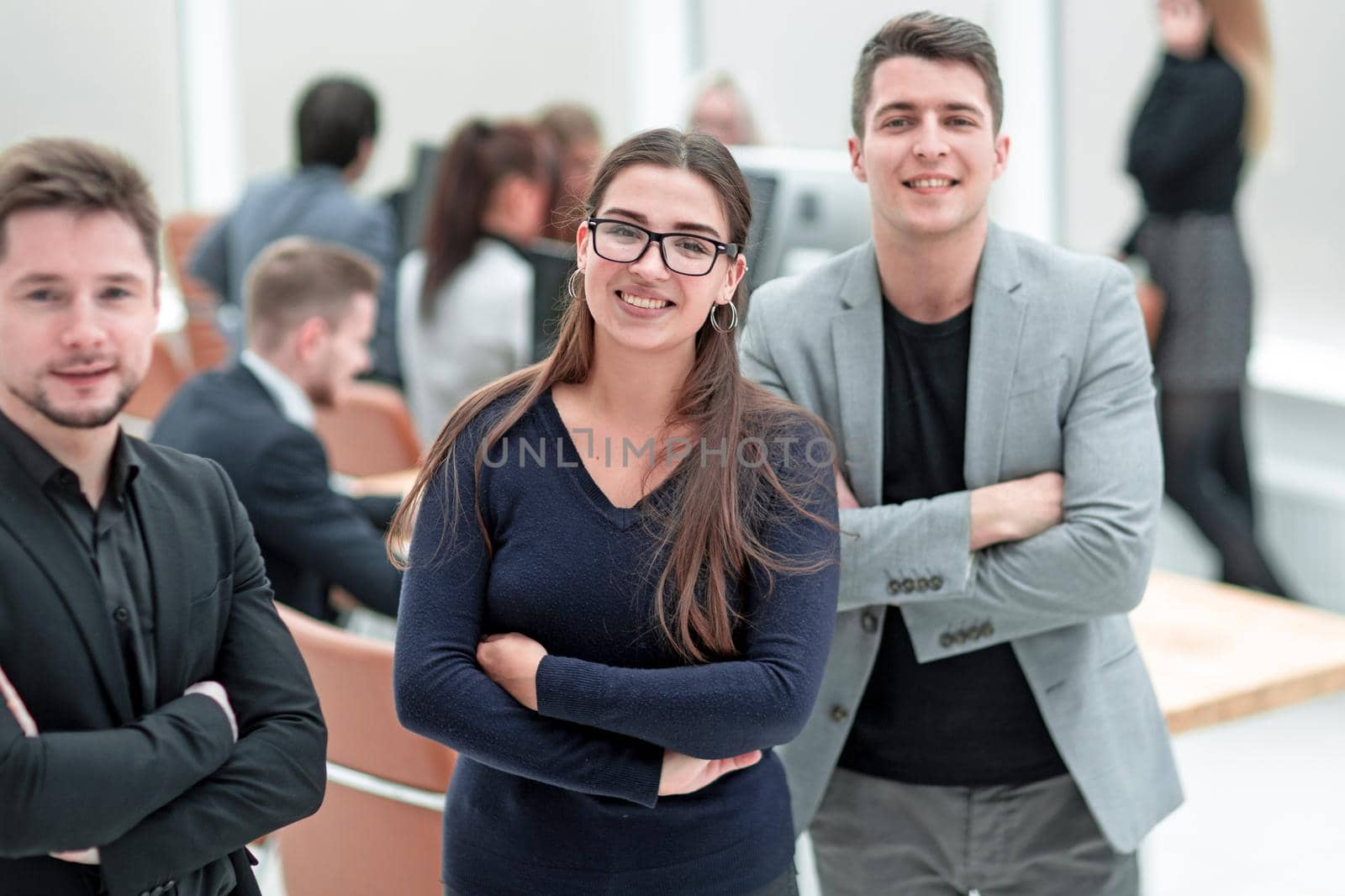 smiling young business woman standing in the office by asdf