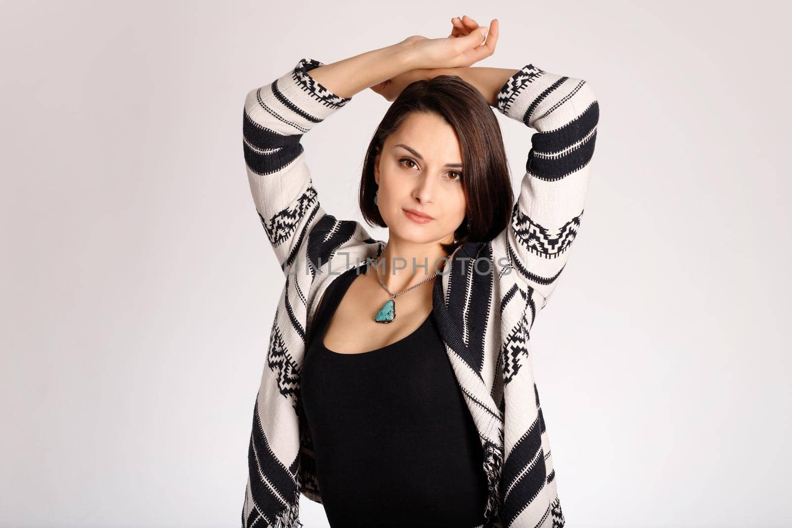 Aztec print clothes on beautiful fashion young woman on white background.