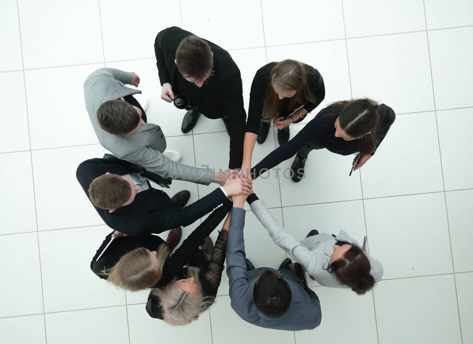 top view. group of young business people joining their palms together by asdf