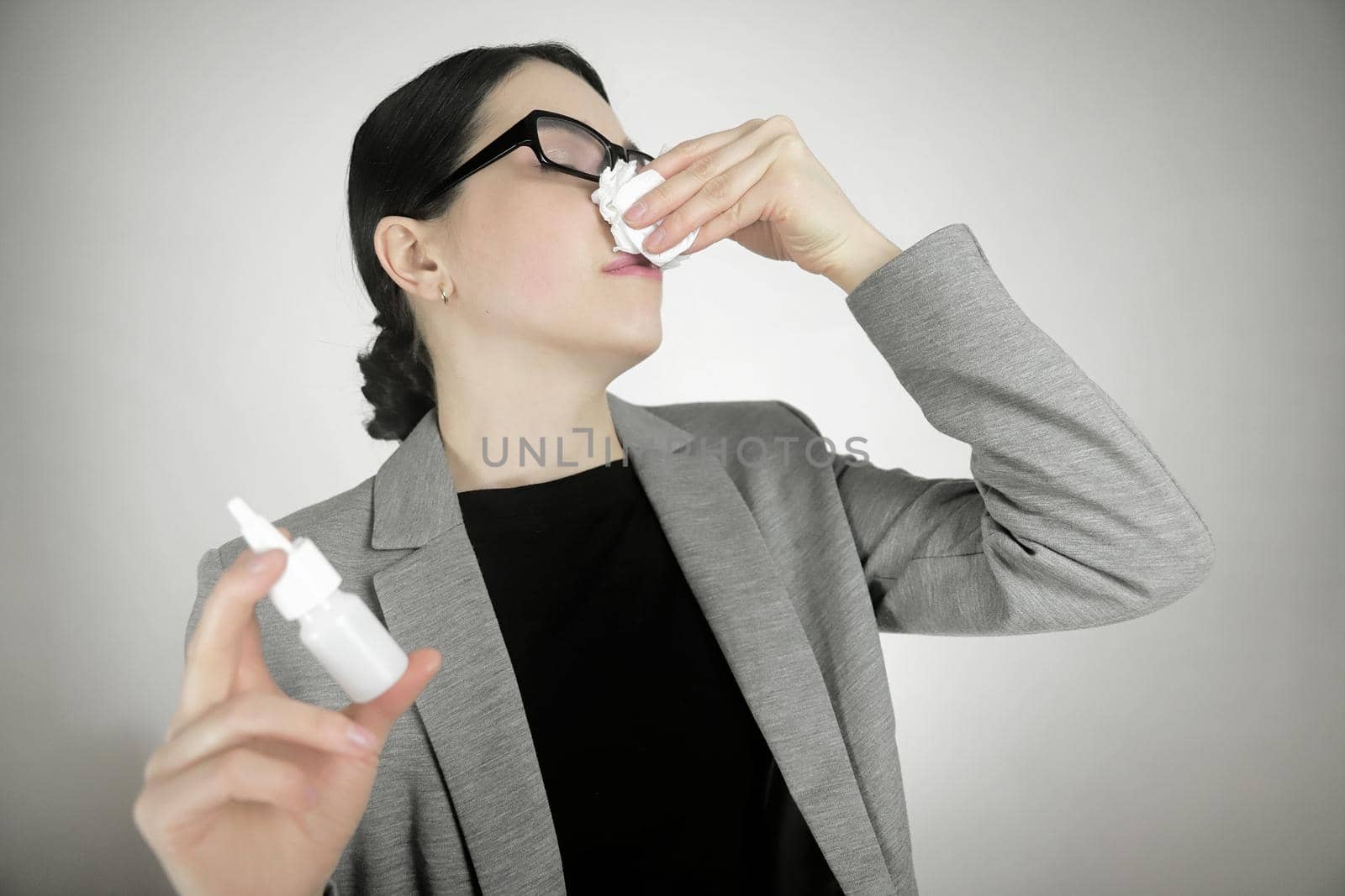 Treating a runny nose or common cold with a nasal spray.