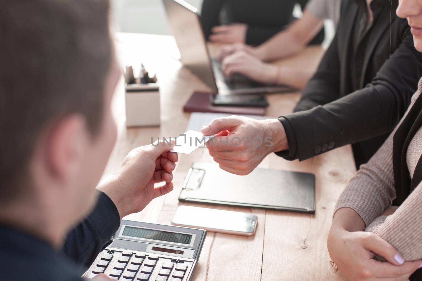 Business people board meeting in modern office while sitting at round table