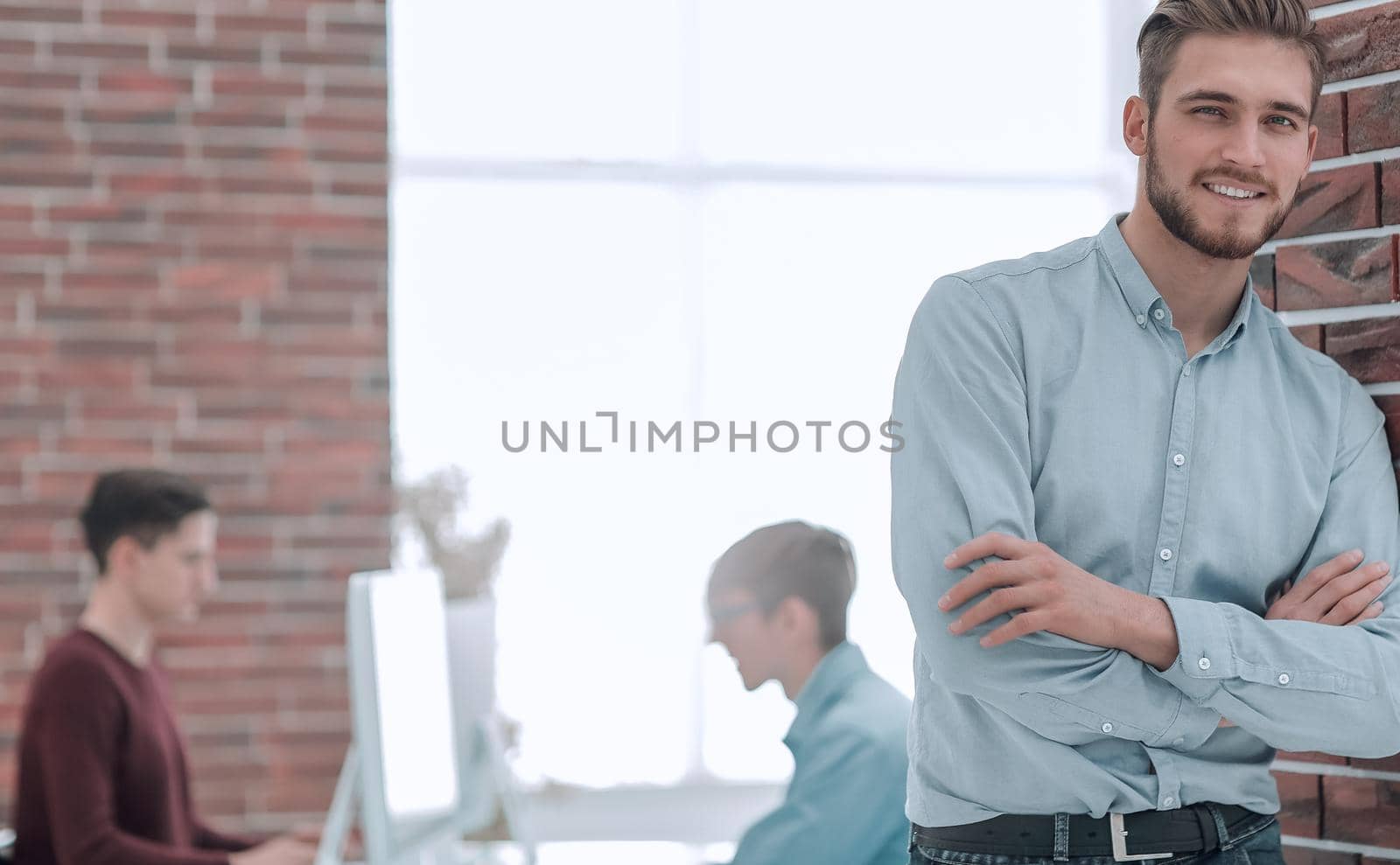 Businessman with colleagues in the background in office