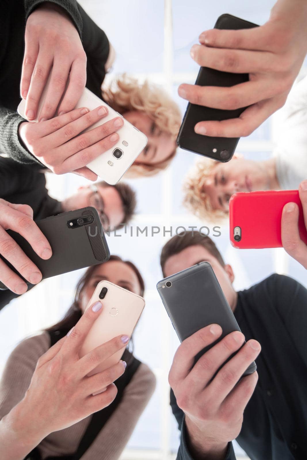 Group of businessman hold smartphones. bottom view by asdf