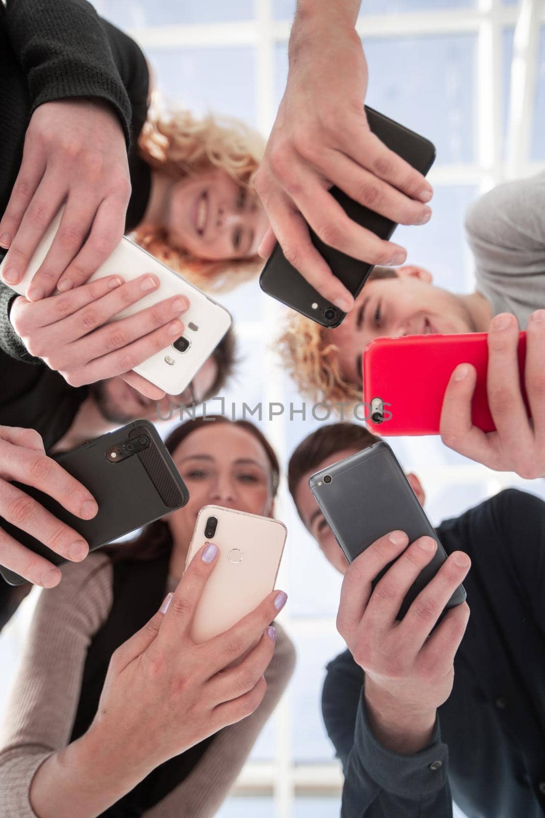 Group of businessman hold smartphones. bottom view by asdf