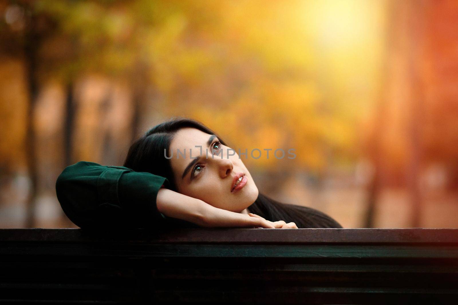 Autumn portrait of young dreaming girl in autumn park.